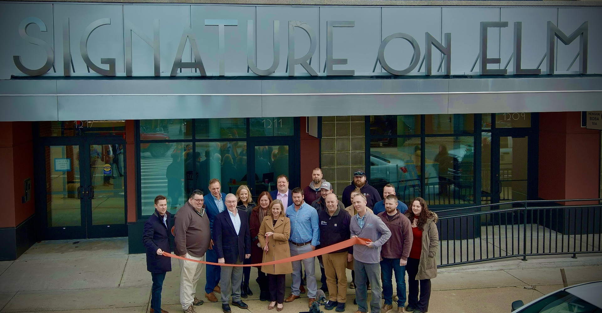 Ribbon cutting ceremony in front of the Signature on Elm building in Manchester, NH